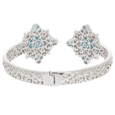 Sterling silver cuff bracelet featuring intricate filigree design and turquoise accents, elegant jewelry piece.